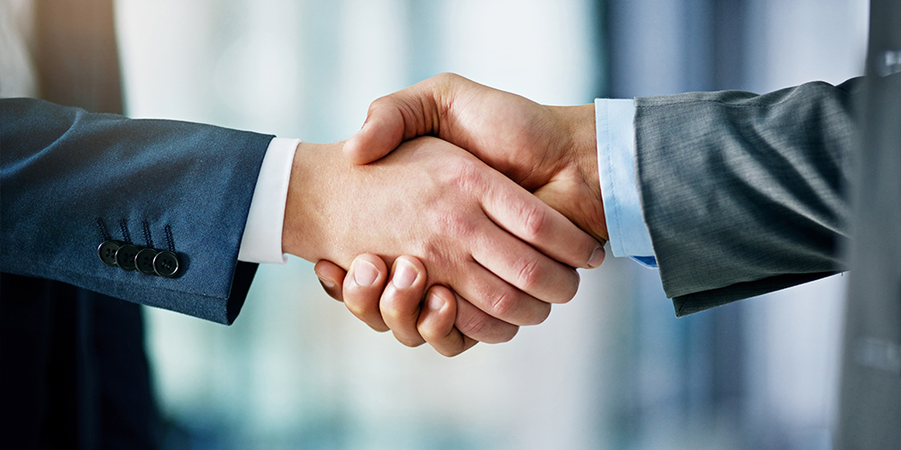 handshake illustrerer ledig stilling som salgsdirektør
